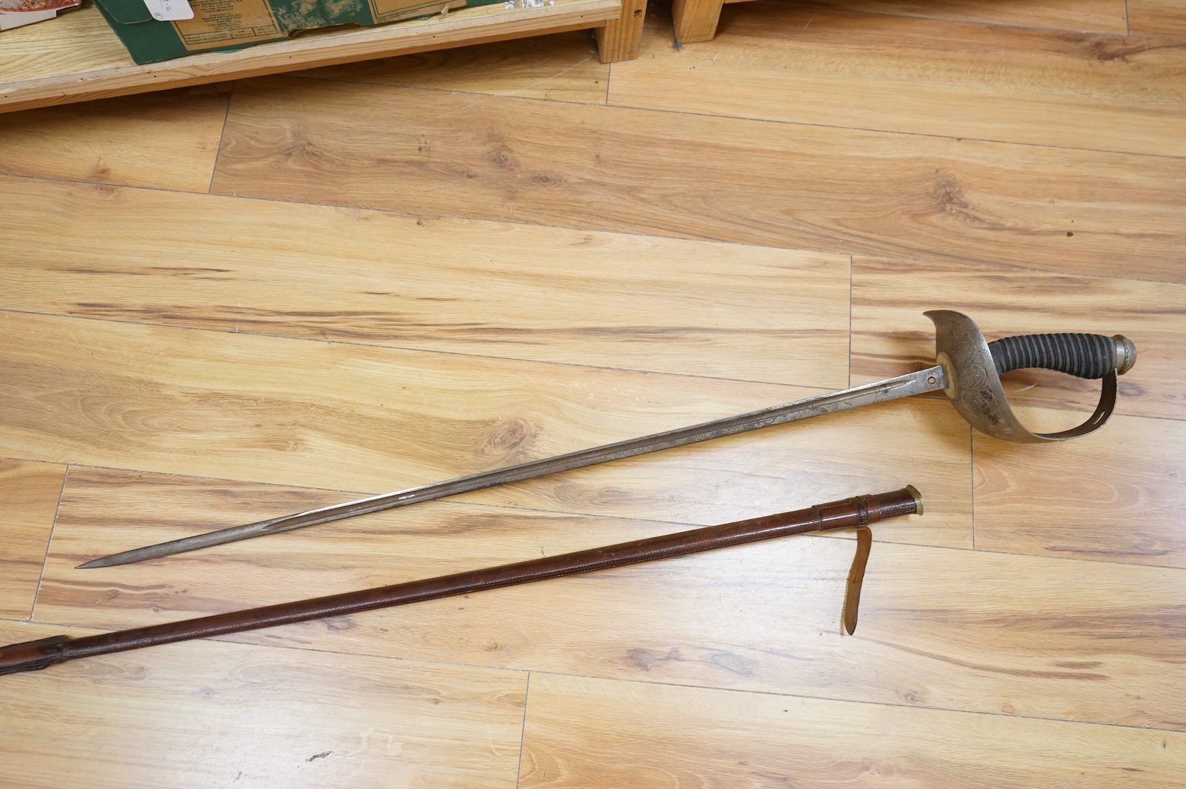 A 1911 pattern cavalry officer’s sword by J. Gaunt and son, etched with crowned GVR cipher and owner’s initials; HPH, regulation hilt and leather covered scabbard